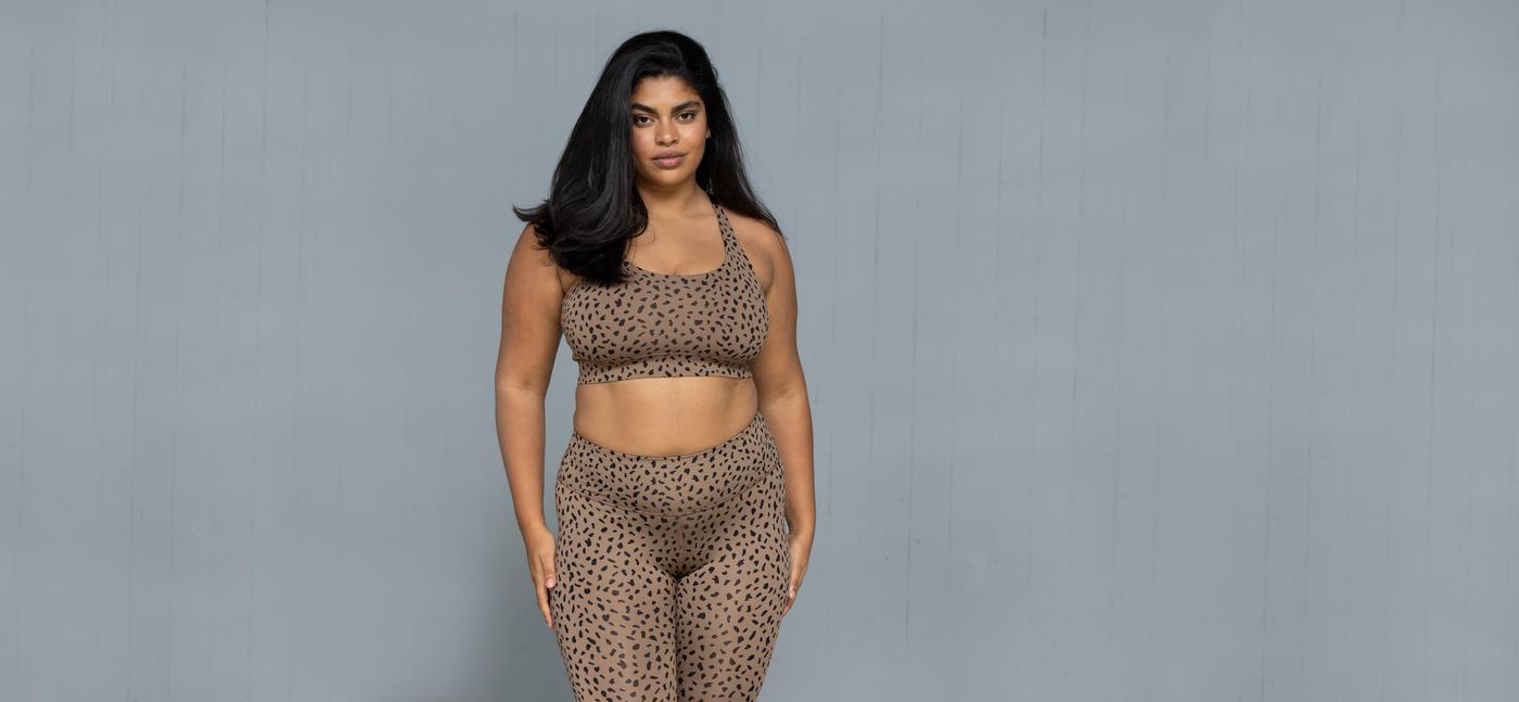 Hey Honey model in a leopard print sports bra and matching leggings.